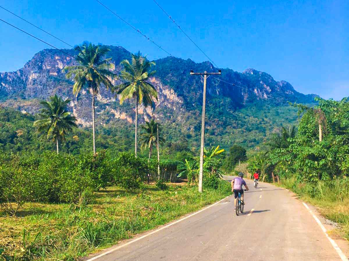 Cycling with a stunning backdrop on our Bangkok and the River Kwai Bike Tour Cycling with a stunning backdrop on our Bangkok and the River Kwai Bike Tour